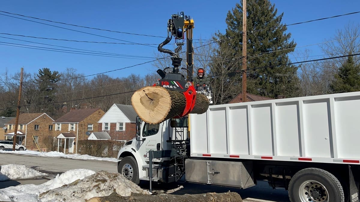 A recovered log being loaded onto the Landforce truck